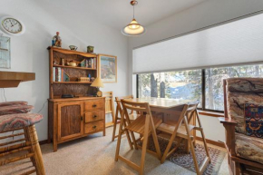 Feel your cares melt away as you relax next to the wood burning fireplace and enjoy the natural light and scenery Tamarack Condo 17 condo